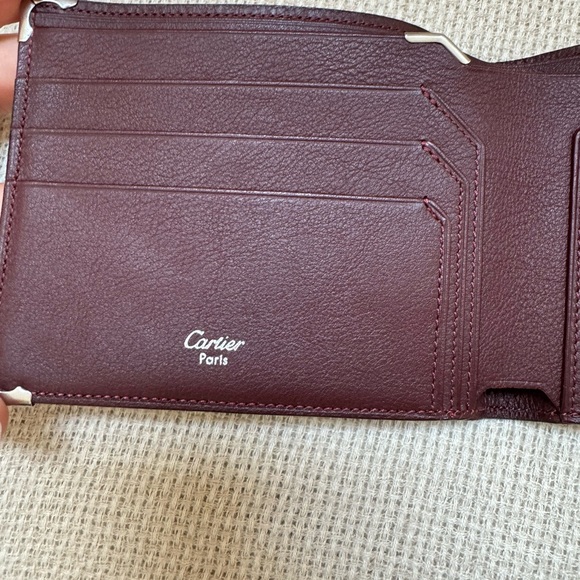 Cartier wallet. NWOT Brown exterior, burgundy interior. Shopping bag included. - Picture 5 of 10
